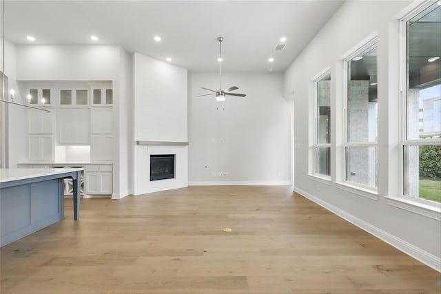 6300 Whitebrush Pl, Fort Worth, TX 76123 - unfurnished living room featuring ceiling fan, a fireplace, light wood finished floors, baseboards, and recessed lighting