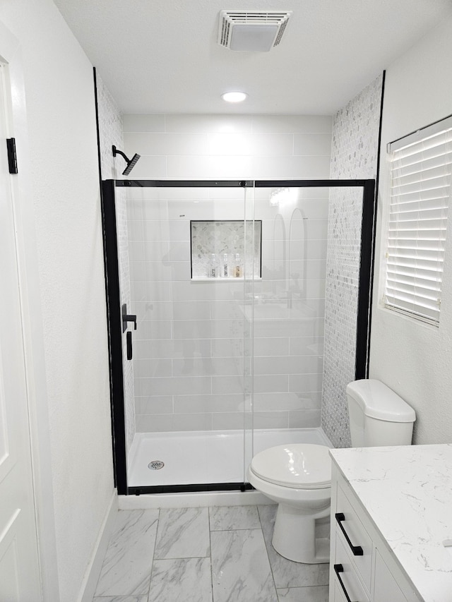 bathroom with vanity, toilet, and walk in shower