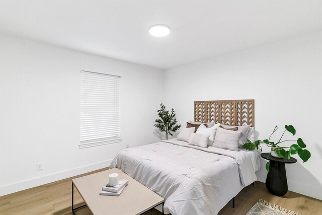 bedroom with hardwood / wood-style flooring