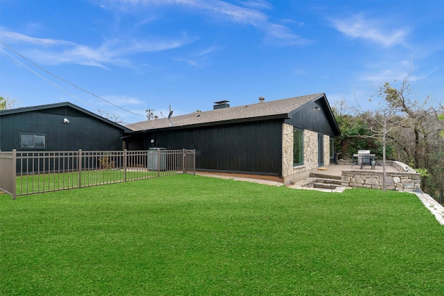 back of house featuring a patio and a lawn