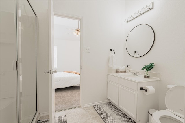 bathroom featuring vanity, ceiling fan, toilet, and a shower with door