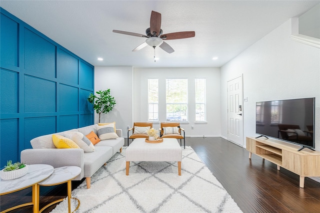 living room with ceiling fan and hardwood / wood-style flooring