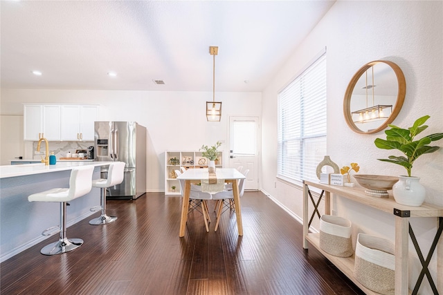 dining room with dark hardwood / wood-style flooring and sink