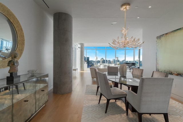 dining room with light hardwood / wood-style flooring and a notable chandelier