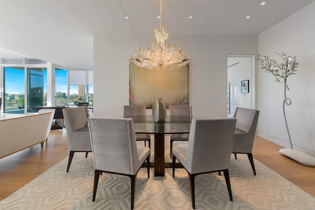 dining room featuring a notable chandelier and light wood-type flooring