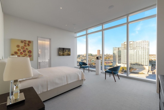 bedroom featuring carpet and a wall of windows