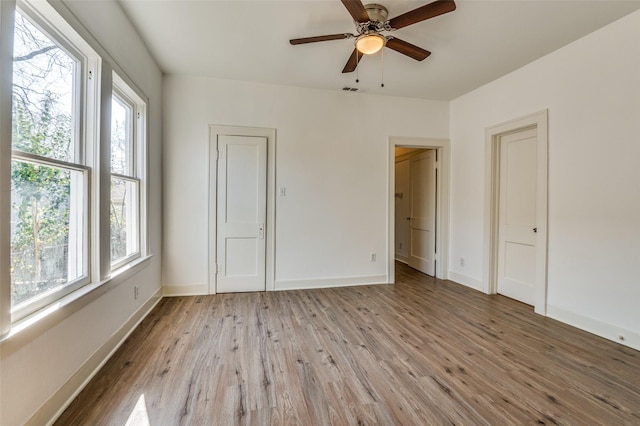 unfurnished bedroom featuring ceiling fan and light wood-type flooring