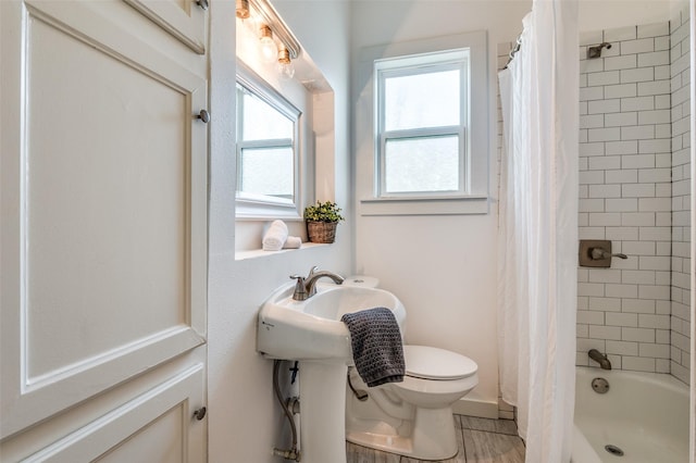 bathroom featuring shower / bathtub combination with curtain and toilet