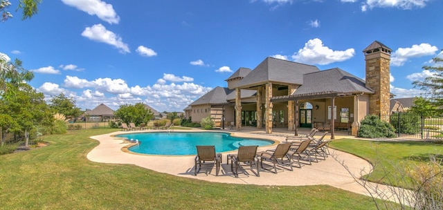 view of pool featuring a lawn and a patio