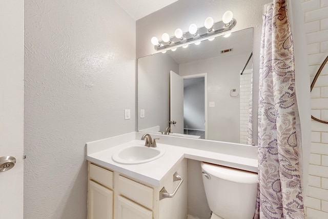 bathroom with vanity, a shower with curtain, and toilet