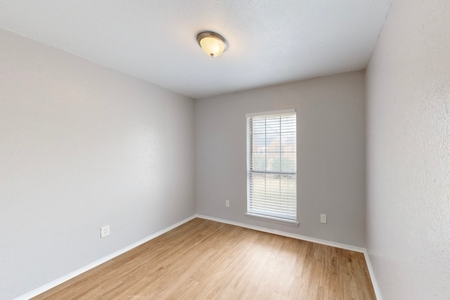 unfurnished room with wood-type flooring