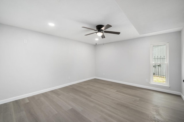 unfurnished room with hardwood / wood-style flooring and ceiling fan