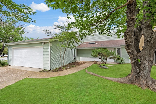 ranch-style home featuring a garage and a front lawn