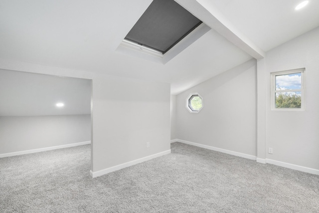 bonus room featuring plenty of natural light, carpet floors, and lofted ceiling