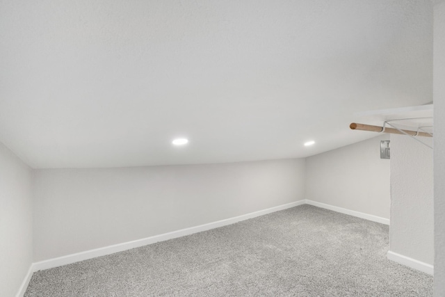 interior space with carpet flooring and lofted ceiling