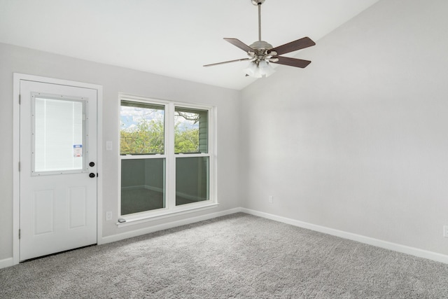 unfurnished room with carpet flooring, ceiling fan, and vaulted ceiling