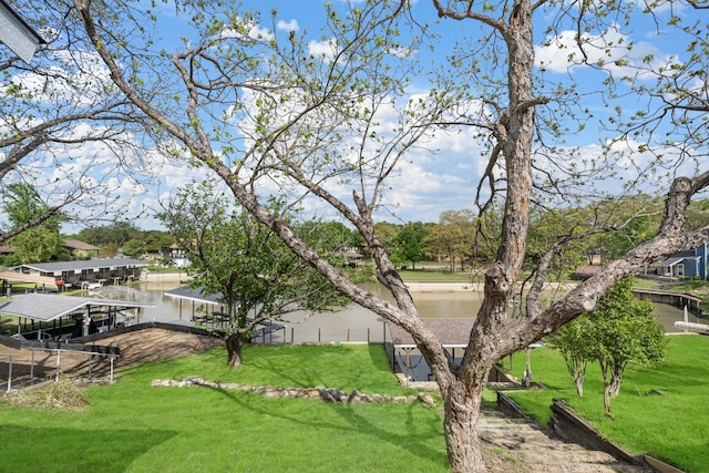 view of property's community with a water view and a yard