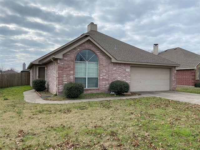 single story home featuring a front lawn and a garage