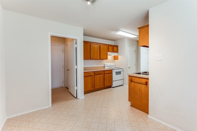 kitchen with sink and white electric range oven