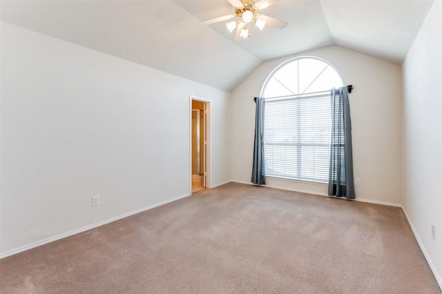 carpeted spare room featuring ceiling fan and lofted ceiling