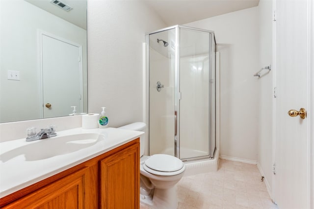 bathroom with vanity, toilet, and a shower with door