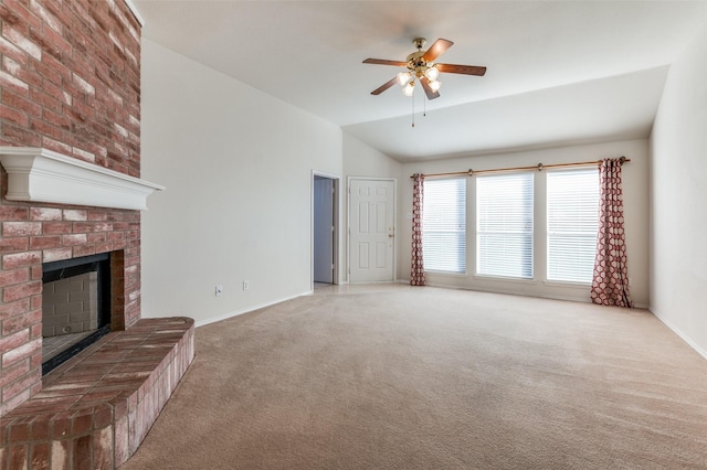 unfurnished living room featuring ceiling fan, a fireplace, carpet floors, and lofted ceiling