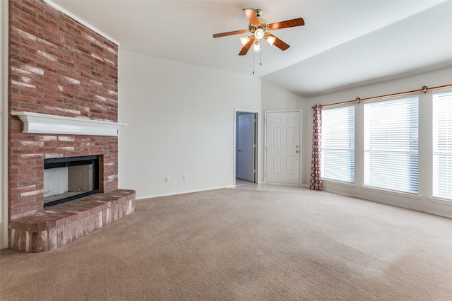 unfurnished living room with a fireplace, carpet floors, vaulted ceiling, and ceiling fan