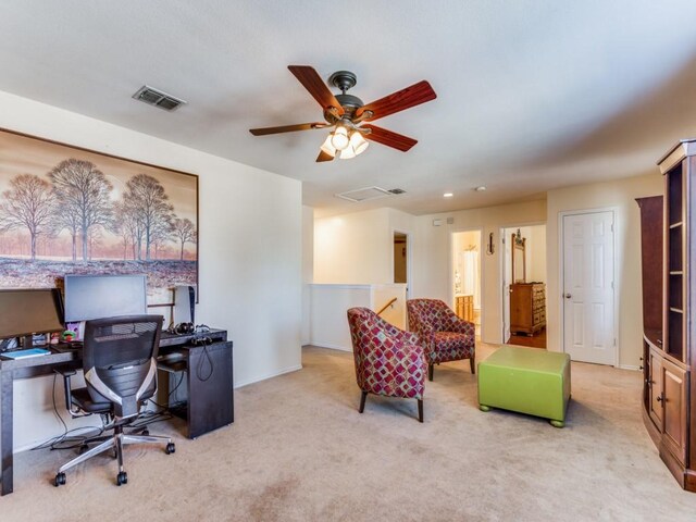 carpeted office space with ceiling fan