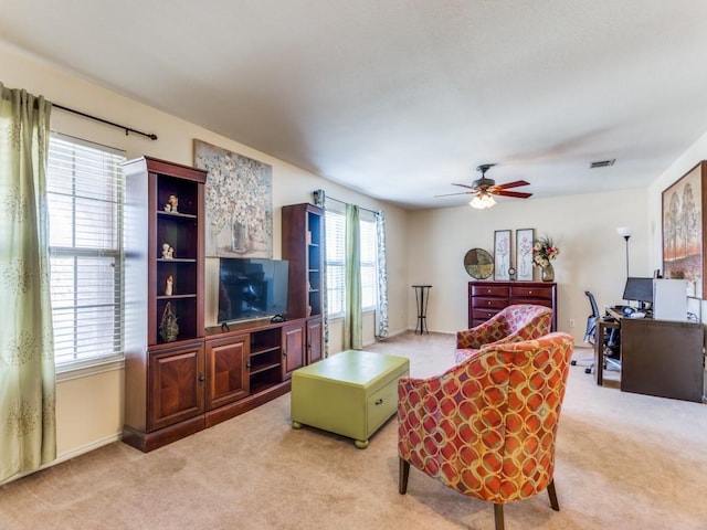 living room featuring light carpet and ceiling fan