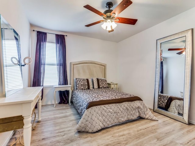 bedroom with ceiling fan and light hardwood / wood-style floors