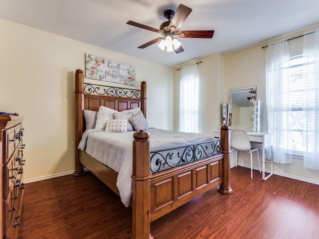 bedroom featuring multiple windows, ceiling fan, and dark hardwood / wood-style floors