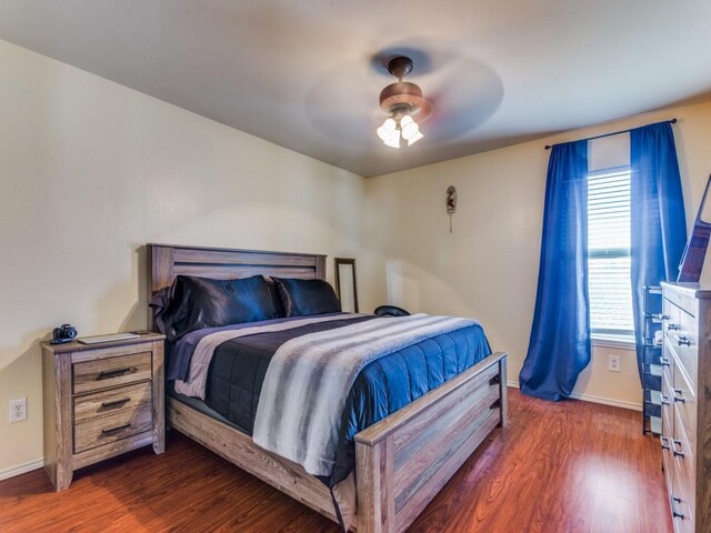 bedroom featuring ceiling fan and dark wood-type flooring