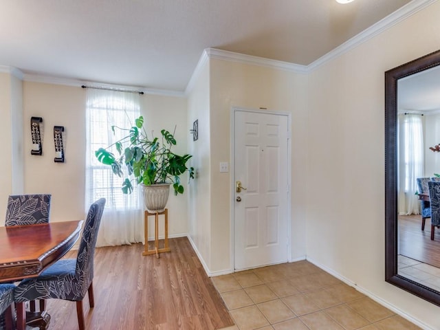 foyer with light tile patterned flooring and ornamental molding