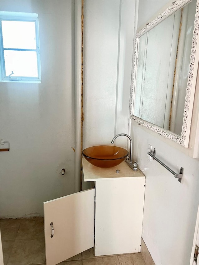 bathroom with tile patterned flooring and vanity