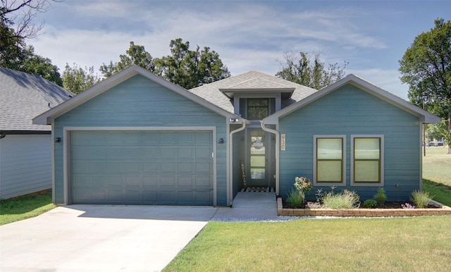 view of front of home with a garage and a front lawn