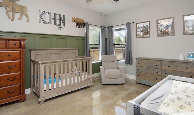 bedroom with ceiling fan and a crib