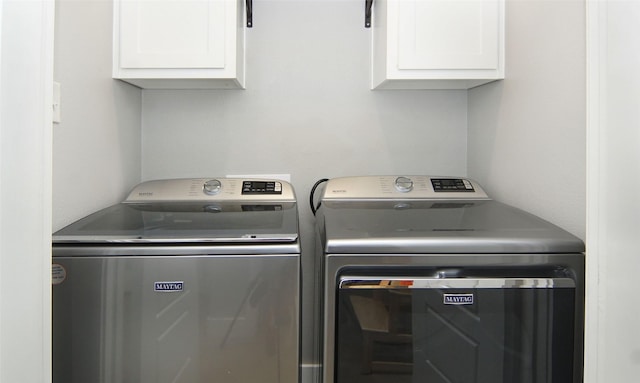 laundry room with cabinets and separate washer and dryer