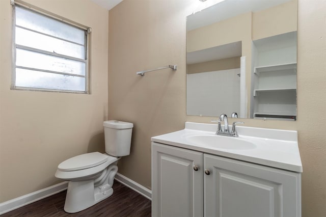 bathroom featuring wood-type flooring, vanity, and toilet