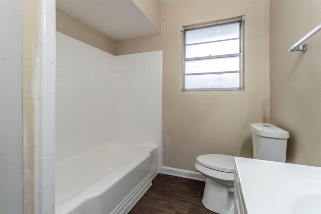 full bathroom featuring vanity, hardwood / wood-style flooring, toilet, and washtub / shower combination