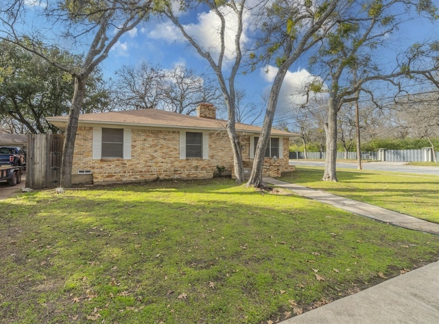 ranch-style home with a front lawn