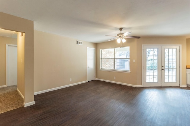 empty room with dark hardwood / wood-style flooring, french doors, and ceiling fan