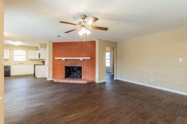 unfurnished living room featuring dark wood-type flooring, a fireplace, and ceiling fan