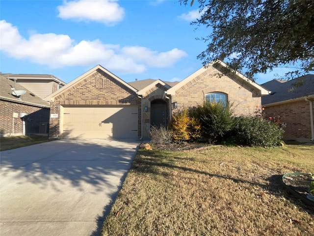 view of front of property featuring a garage and a front lawn