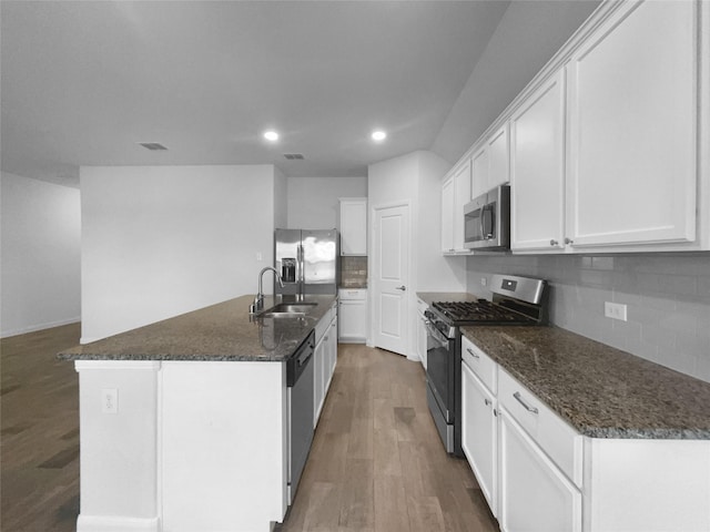 kitchen with sink, a center island with sink, dark hardwood / wood-style flooring, stainless steel appliances, and white cabinets