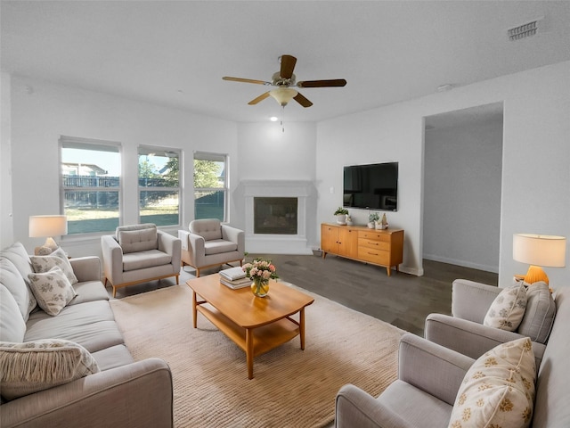 living room with dark hardwood / wood-style floors and ceiling fan