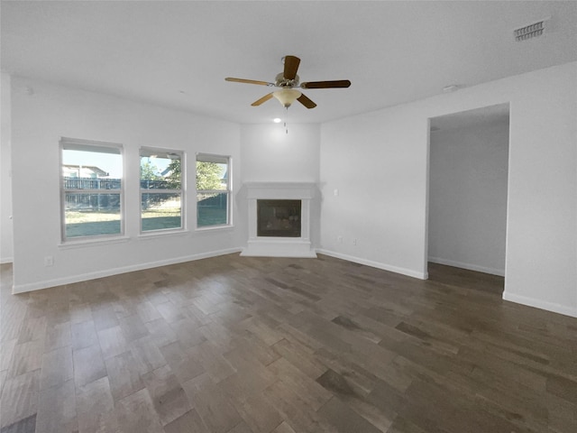 unfurnished living room featuring ceiling fan and dark hardwood / wood-style flooring