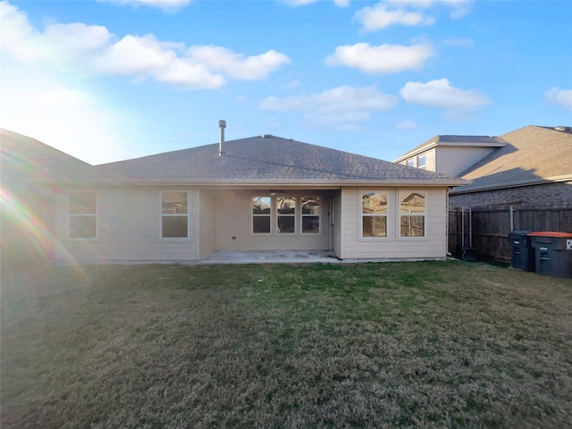 back of house with a patio and a lawn