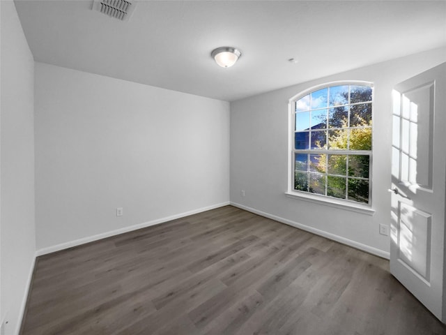 spare room featuring dark hardwood / wood-style floors