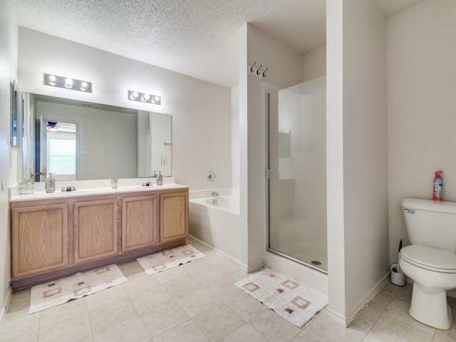 full bathroom with vanity, tile patterned floors, toilet, a textured ceiling, and shower with separate bathtub