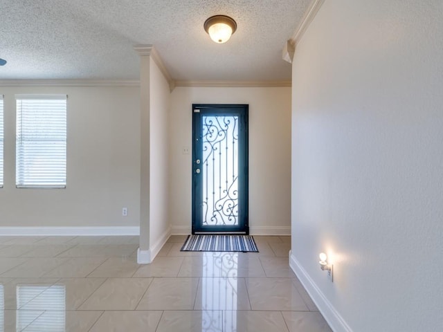 foyer with a textured ceiling and crown molding